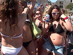 Sensual babes in bikinis and shorts with sexy bodies dancing at an outdoor party