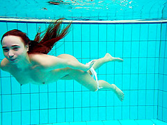 Russian redhead teen with small tits dives deep in the pool