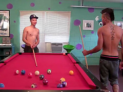 Jorge and Tiger are having a friendly game of billiards in the rec room