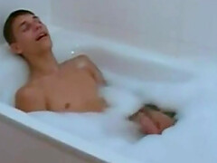 sweet hottie jerking his dick in a bathtub full of foam