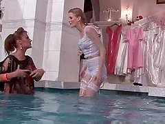 Blonde lesbian duo having fun wet in the pool