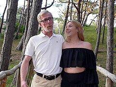 An old guy and a young girl are having sex in nature
