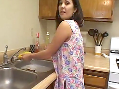 Latin houswife gives a blowjob to her busband in a kitchen