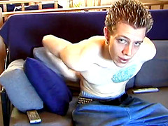 Shane relaxes on the sofa, while watching a porn video and gets totally into himself.