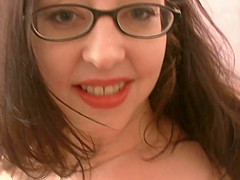 Long haired teen brunette sucks a cock while wearing glasses