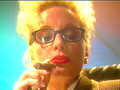 Blonde mature lady with glasses smokes a cigar and plays with her tits